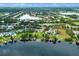 An aerial view showcases a lakeside community with private boat docks and lush green landscaping at 13120 Zori Ln, Windermere, FL 34786