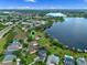 Aerial view showcasing the location of a waterfront home with lake access, surrounded by beautiful landscape at 13120 Zori Ln, Windermere, FL 34786