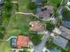 Aerial view of luxury homes with green lawns, pools, and lake access in a desirable neighborhood at 13120 Zori Ln, Windermere, FL 34786