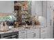 Elegant bar area featuring stone counters, mirrored backsplash, and pendant lighting at 13120 Zori Ln, Windermere, FL 34786