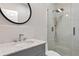 Modern bathroom featuring marble tiles, glass shower, and a stylish vanity at 13120 Zori Ln, Windermere, FL 34786
