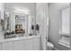 This bright bathroom includes a walk-in shower, modern vanity, and access to adjoining bedroom at 13120 Zori Ln, Windermere, FL 34786