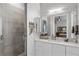 Bright bathroom featuring a walk-in shower with glass door and vanity with ample storage at 13120 Zori Ln, Windermere, FL 34786