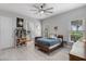 This cozy bedroom features natural light, a ceiling fan, and is decorated with personal touches at 13120 Zori Ln, Windermere, FL 34786