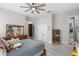 This bedroom features a ceiling fan, natural light, and offers access to ensuite bath and closet at 13120 Zori Ln, Windermere, FL 34786