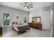 Charming bedroom boasts natural light, a ceiling fan, and stylish decor for a cozy retreat at 13120 Zori Ln, Windermere, FL 34786