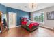 Large primary bedroom with hardwood floors, ensuite bathroom, and stylish decor at 13120 Zori Ln, Windermere, FL 34786
