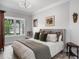 Bedroom featuring a cozy bed, large window with natural light, and neutral color palette at 13120 Zori Ln, Windermere, FL 34786