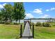 Wooden dock extends into the lake, offering a serene and picturesque waterfront view with blue sky at 13120 Zori Ln, Windermere, FL 34786