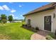 Well-manicured lawn with a view of the lake and a side entry door with brick paver walkway at 13120 Zori Ln, Windermere, FL 34786