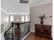 Upstairs hallway featuring hardwood floors, black railings, and stylish decor at 13120 Zori Ln, Windermere, FL 34786