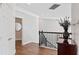 Upstairs hallway featuring hardwood floors, black railings, and stylish decor at 13120 Zori Ln, Windermere, FL 34786