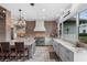 Spacious kitchen featuring stone counters, brick accents, large island and a view of the lake at 13120 Zori Ln, Windermere, FL 34786