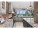 Bright kitchen featuring stone counters, stainless steel appliances, and a view of the lake at 13120 Zori Ln, Windermere, FL 34786