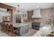 Large kitchen featuring stone counters, brick accents, large island and stainless steel appliances at 13120 Zori Ln, Windermere, FL 34786
