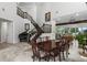 Elegant living room with high ceilings, staircase, piano, and dining room with lake view at 13120 Zori Ln, Windermere, FL 34786