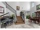 Elegant living room with high ceilings, staircase, piano, and dining room at 13120 Zori Ln, Windermere, FL 34786