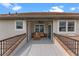 Lovely covered patio with a ceiling fan and water view at 13120 Zori Ln, Windermere, FL 34786