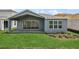 Backyard featuring a covered patio, grey exterior paint, and a well-manicured lawn at 13123 Faro Ct # 23, Winter Garden, FL 34787
