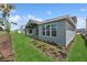 Backyard featuring a covered patio, grey exterior paint, and a well-manicured lawn at 13123 Faro Ct # 23, Winter Garden, FL 34787