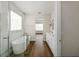 Modern bathroom with a freestanding tub, glass shower, and double vanity with wood-look flooring at 13123 Faro Ct # 23, Winter Garden, FL 34787
