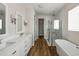 Bright primary bathroom featuring double vanity, free-standing tub, and glass shower at 13123 Faro Ct # 23, Winter Garden, FL 34787