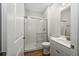 Modern bathroom featuring a walk-in glass shower with white subway tiles, vanity sink, and wood flooring at 13123 Faro Ct # 23, Winter Garden, FL 34787