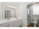 Bright bathroom with double vanity, shower, and natural light from the window at 13123 Faro Ct # 23, Winter Garden, FL 34787