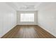 Bright, airy bedroom with wood-look floors, paneled accent wall and ceiling fan at 13123 Faro Ct # 23, Winter Garden, FL 34787