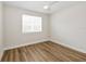 Bedroom with wood floors, a ceiling fan, and a bright window at 13123 Faro Ct # 23, Winter Garden, FL 34787
