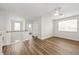 Bedroom features wood-look floors, a ceiling fan, and a bright window at 13123 Faro Ct # 23, Winter Garden, FL 34787