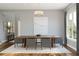 Bright dining area with a modern chandelier, a long wood table, and comfortable seating at 13123 Faro Ct # 23, Winter Garden, FL 34787