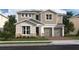 Charming two-story home with a two-car garage, stone accents, and landscaped front yard at 13123 Faro Ct # 23, Winter Garden, FL 34787