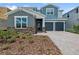 Charming two-story home featuring stone accents, a two-car garage, and a beautifully landscaped front yard at 13123 Faro Ct # 23, Winter Garden, FL 34787