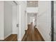 Hallway featuring hardwood floors, modern wainscoting, and views of the home's staircase at 13123 Faro Ct # 23, Winter Garden, FL 34787