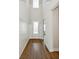 Hallway with hardwood flooring, modern wainscoting, and a front door allowing natural light at 13123 Faro Ct # 23, Winter Garden, FL 34787