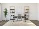 Contemporary home office setup with a glass desk, open shelving, and stylish decor at 13123 Faro Ct # 23, Winter Garden, FL 34787