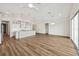 Open floor plan featuring a modern kitchen with an island and a living area with sliding glass doors at 13123 Faro Ct # 23, Winter Garden, FL 34787