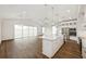 Open-concept kitchen and living area with a large island, stainless steel appliances, and plenty of natural light at 13123 Faro Ct # 23, Winter Garden, FL 34787