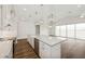 Bright kitchen features stainless steel appliances, a center island with a sink, and an open floor plan at 13123 Faro Ct # 23, Winter Garden, FL 34787