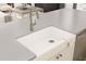 Close-up of a farmhouse-style kitchen sink with a modern faucet and countertops at 13123 Faro Ct # 23, Winter Garden, FL 34787