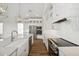 Modern kitchen boasts stainless appliances, wood floors, shaker cabinets and quartz countertops at 13123 Faro Ct # 23, Winter Garden, FL 34787