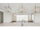 Bright living area featuring wood floors, modern lighting fixtures, and sliding glass doors leading to outdoor views at 13123 Faro Ct # 23, Winter Garden, FL 34787