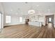 Bright and airy open-concept living area with wood floors, abundant natural light, and a modern kitchen at 13123 Faro Ct # 23, Winter Garden, FL 34787