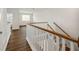 Staircase landing with wood-look floors, white walls and views of the bright, open home at 13123 Faro Ct # 23, Winter Garden, FL 34787