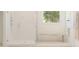 Modern bathroom featuring a frameless glass shower and a light wood bench at 13181 Telsen St # 39, Winter Garden, FL 34787