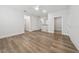 Spacious room featuring stylish wood-look floors, white trim, and ample lighting at 13181 Telsen St # 39, Winter Garden, FL 34787