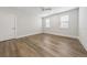 Bedroom featuring stylish wood-look floors, white trim, and natural light at 13181 Telsen St # 39, Winter Garden, FL 34787