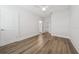 Spacious room featuring stylish wood-look floors, white trim, and ample lighting at 13181 Telsen St # 39, Winter Garden, FL 34787