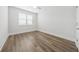 Bedroom featuring stylish wood-look flooring, white trim, and natural light at 13181 Telsen St # 39, Winter Garden, FL 34787